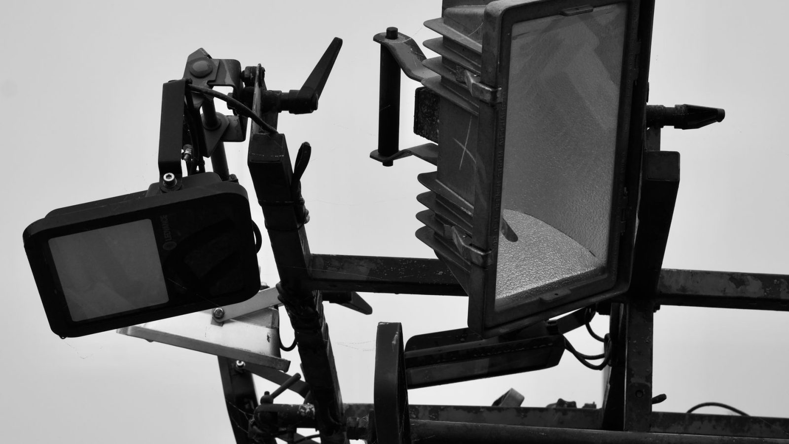Black and white closeup of studio lighting equipment highlighting modern design and industrial look.