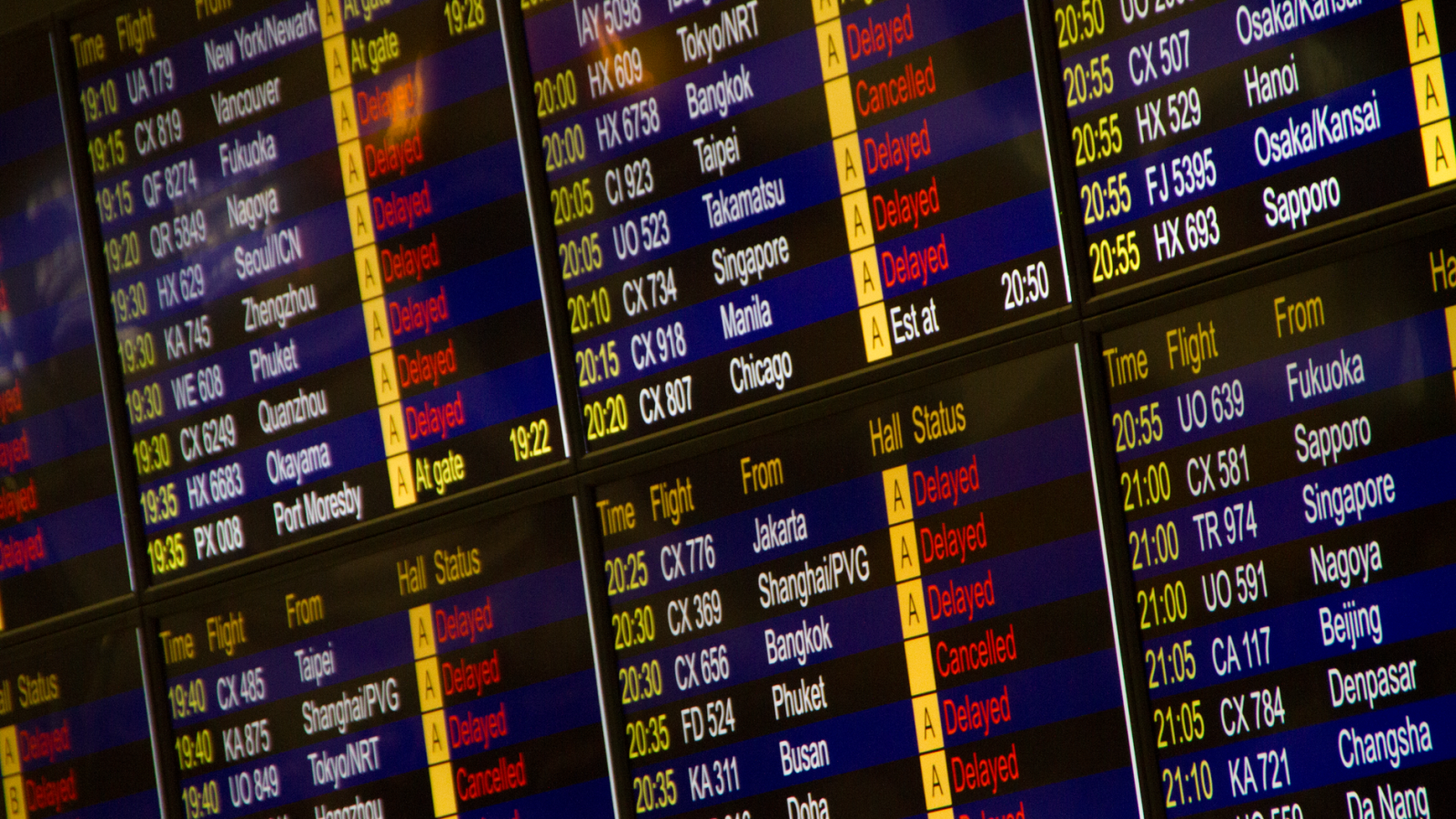 Close-up of digital flight information board showing arrivals and departures at an airport.