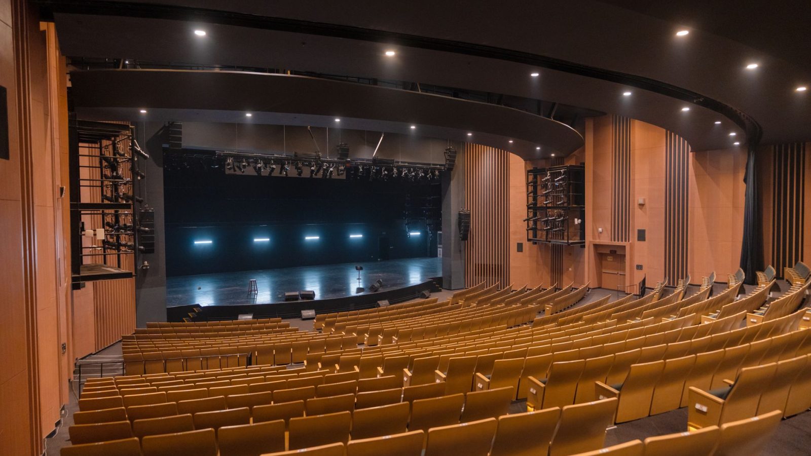 Spacious empty theatre auditorium with wooden seating in Varanasi, India.