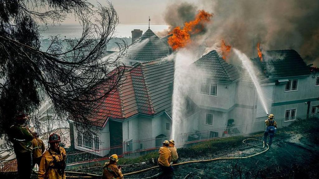 Evacuation orders as fast-moving California wildfire burns homes