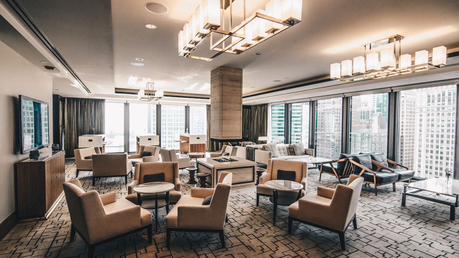 Spacious, modern hotel lounge area with a cityscape view in Chicago, featuring stylish furniture.