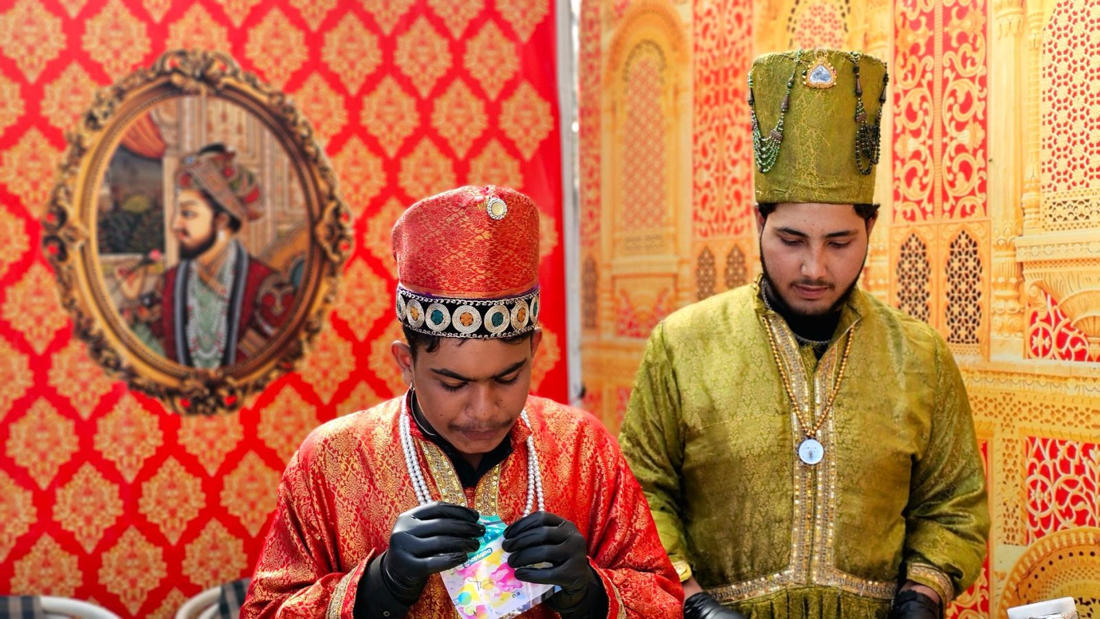 Two men in elaborate Mughal costumes at a cultural event in Islamabad, Pakistan.